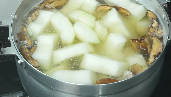 Reduce the heat and simmer until the winter melon is cooked (approximately 20-25 minutes).