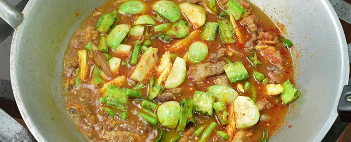 Cook vegetables until tender. Season with fish sauce and seasoning powder. Add sliced red chilies.