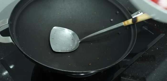 Pound the roasted ingredients into a paste.