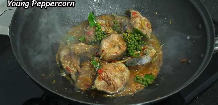 Add young peppercorns, red and blue chili peppers, and bell peppers. Stir-fry until cooked.
