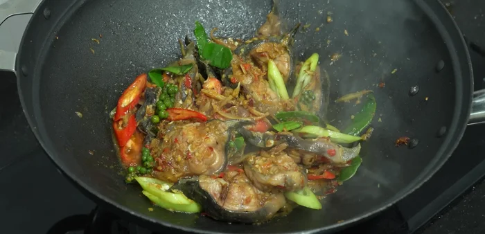 Add basil leaves and stir-fry until wilted.