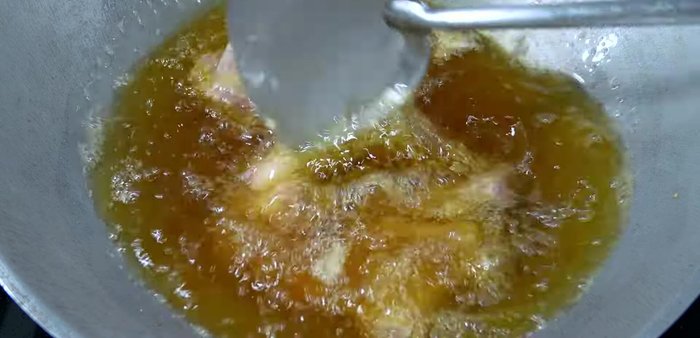 Fry the pork ribs in the same oil over medium-low heat until cooked through. Then, increase the heat to make the outside crispy and golden yellow.