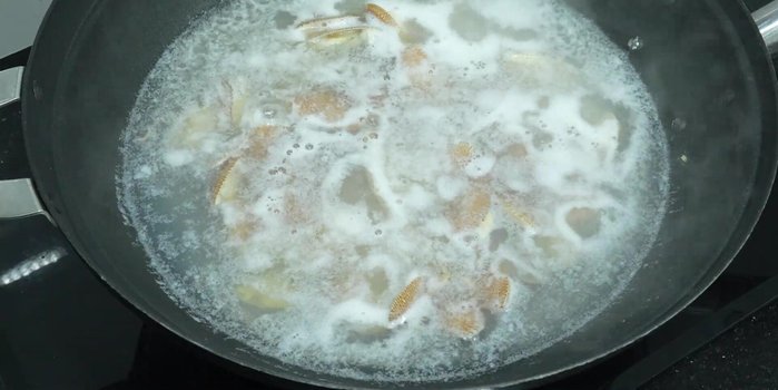 Clean the clams thoroughly, removing any dirt or debris. Boil the clams until cooked.