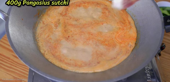 Add the catfish to the boiling curry. Arrange pieces to prevent sticking. (253.08)