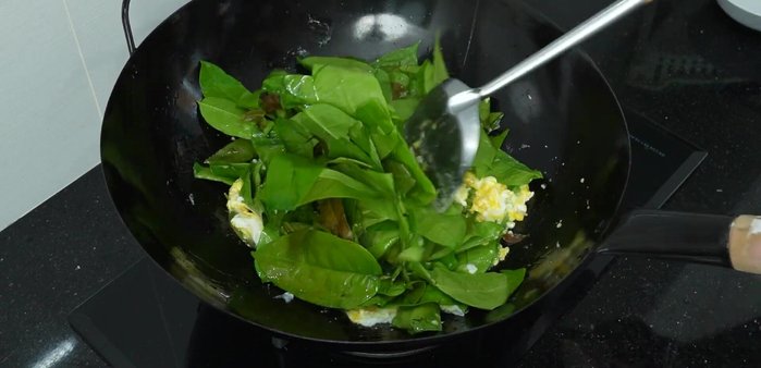 Add morning glory leaves and stir-fry.