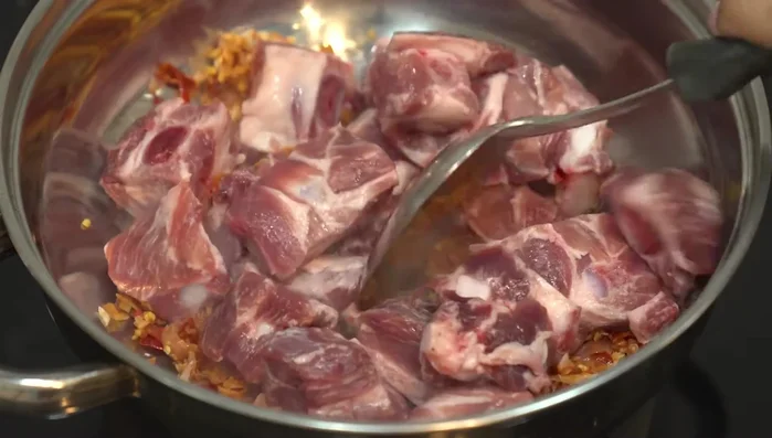 Add the pork ribs to the pan and stir-fry until the skin starts to cook.