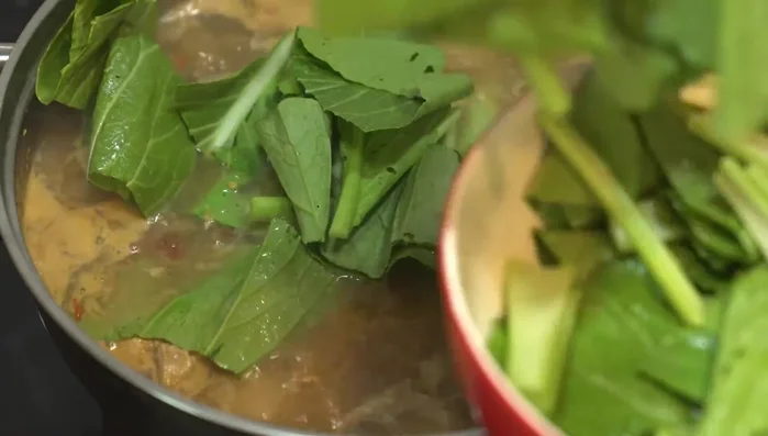 Add the prepared Chinese kale (washed, cut) to the pot and simmer until wilted to your liking.