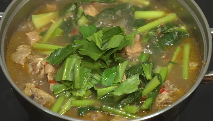 Add chopped cilantro and basil leaves.