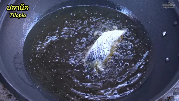 Heat oil in a pan until hot. Fry the tilapia pieces until golden brown and crispy on both sides. Set aside to drain excess oil.