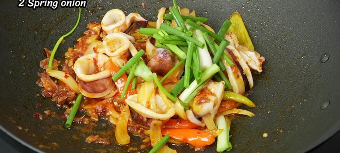 Add spring onions and basil leaves.