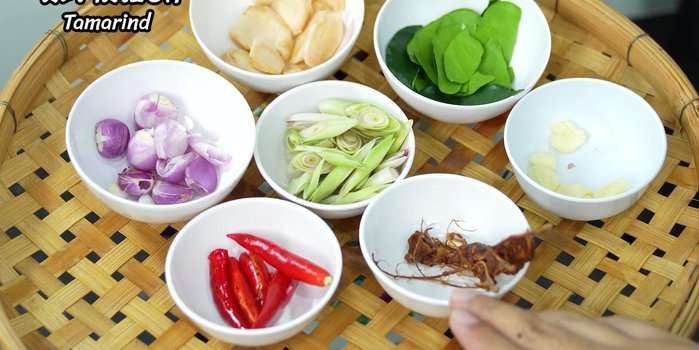 Prepare the aromatics: galangal, lemongrass, kaffir lime leaves, shallots, chili, and pickled tamarind.