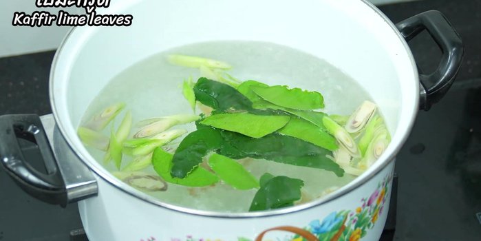 Bring water to a boil in a kettle. Add galangal, lemongrass, kaffir lime leaves, garlic, shallots, and tamarind. Simmer until fragrant.