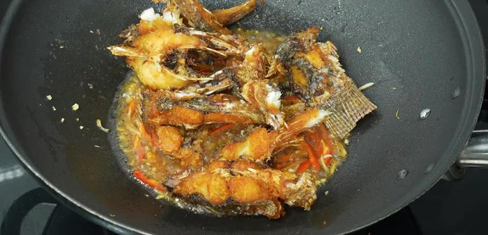Add the fried tilapia (remove bones if desired) and stir to coat in the sauce.