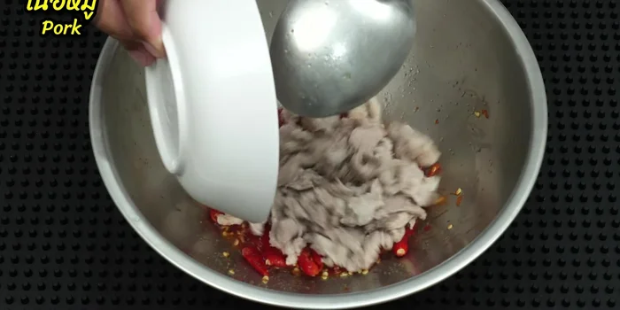 Add the blanched pork to the dressing and mix well to coat the meat.