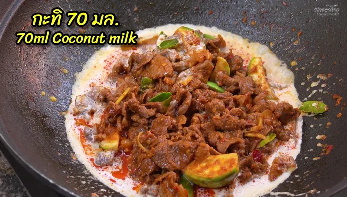 Increase heat to high. Add coconut milk, remaining kaffir lime leaves, young pepper, and diagonally cut chili peppers. Stir-fry to combine.