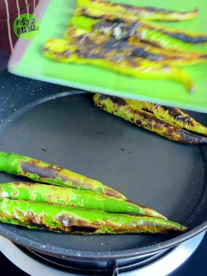 Peel the skin off the grilled chilies.