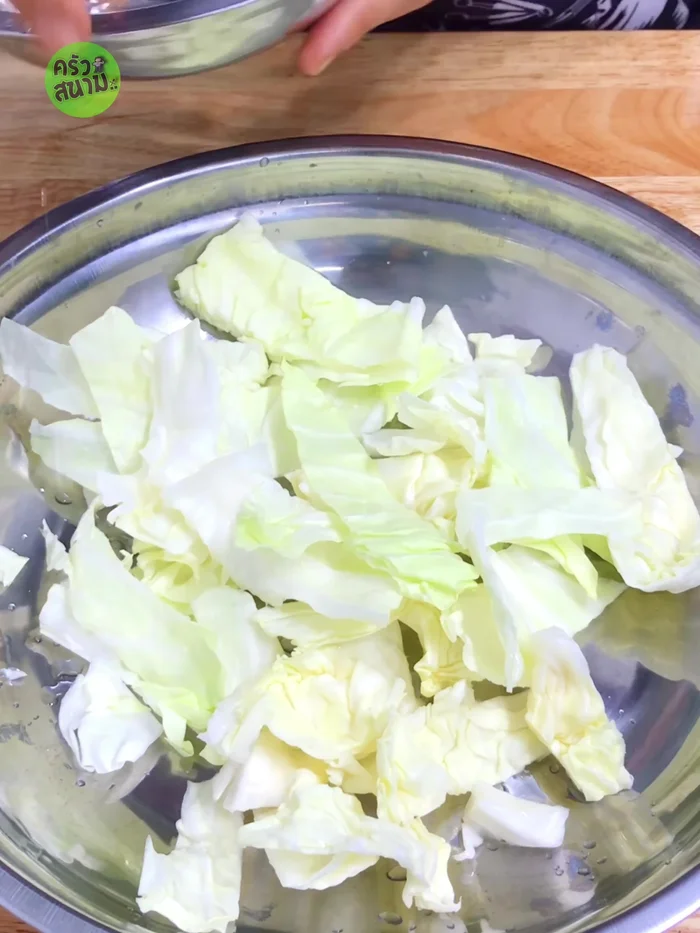 Place shredded cabbage in a steamer basin, add the tilapia, and steam over medium heat for 25 minutes.
