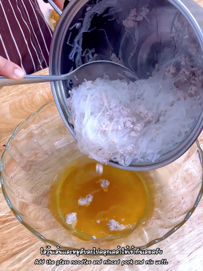 Add the cooked glass noodles and pork to the dressing. Mix well.