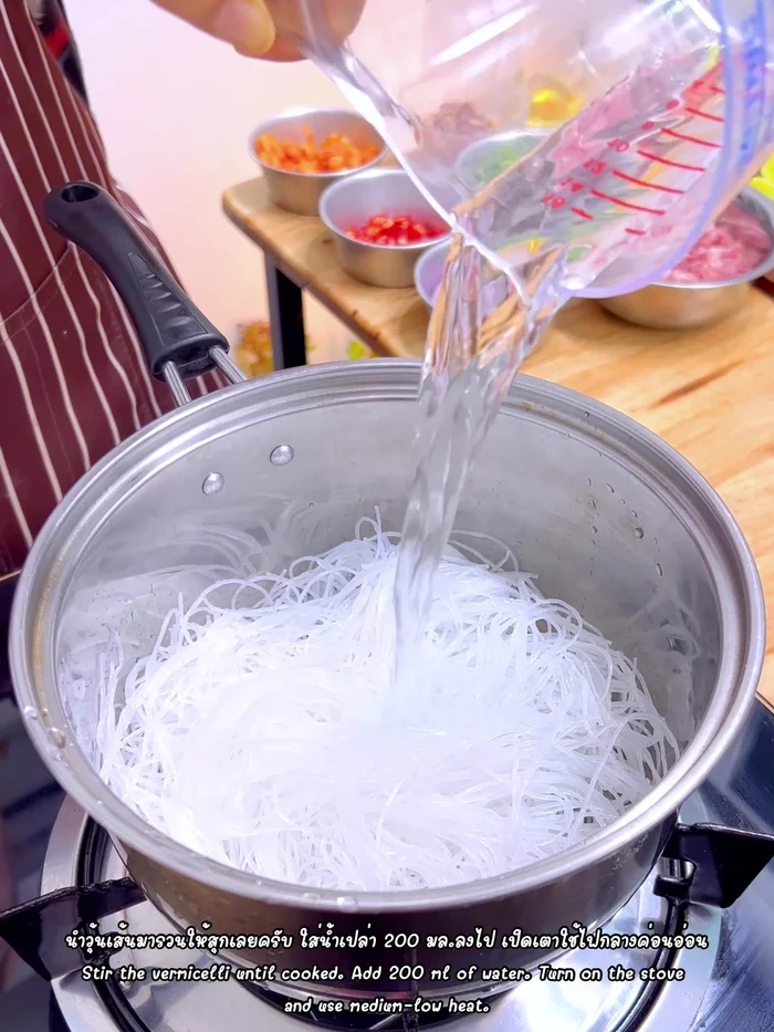 Stir-fry the glass noodles in a pan with 200ml of water over medium-low heat until translucent and puffed up but not mushy.