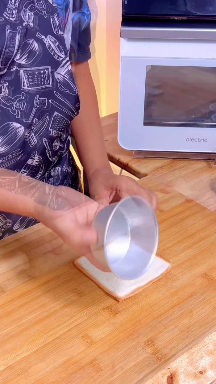 Use a round cup to cut out circles from the bread slices.