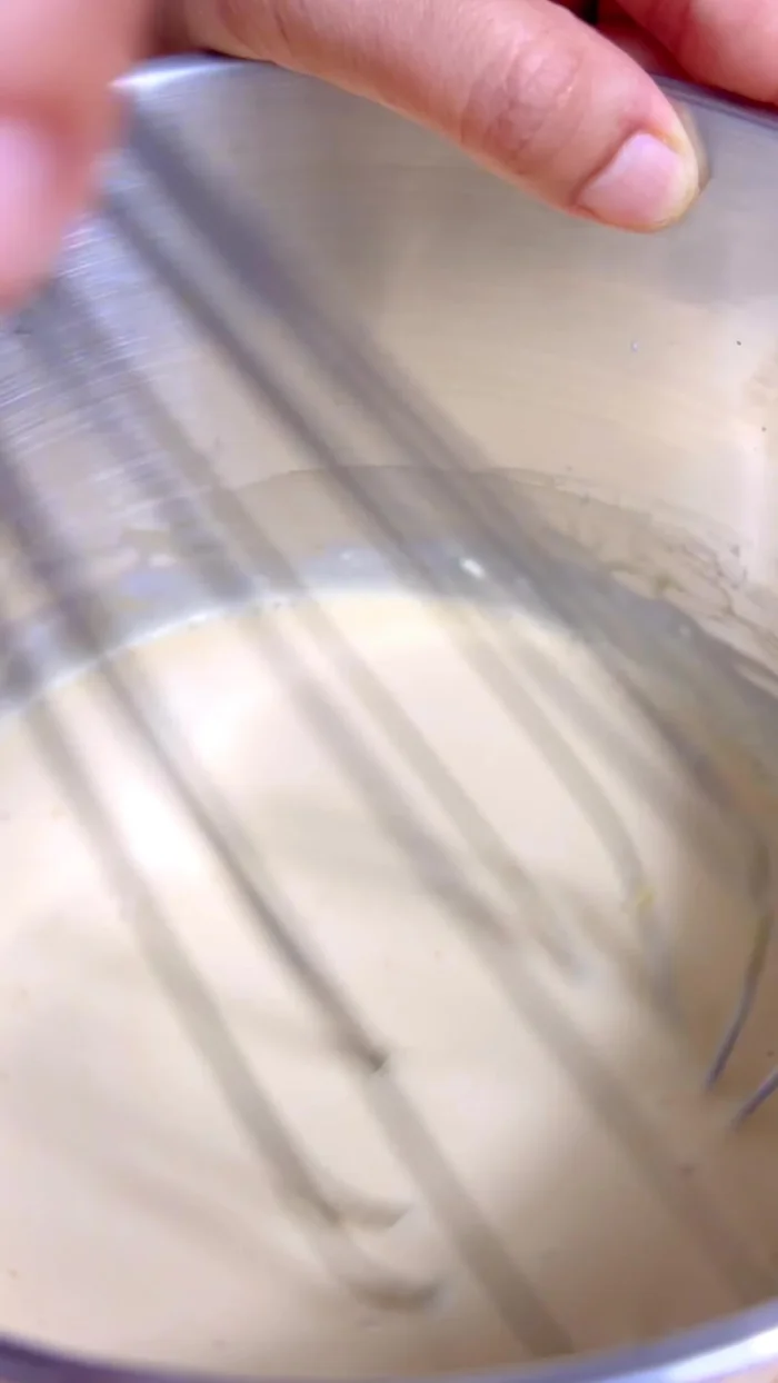 Strain the egg cream mixture to remove any lumps.