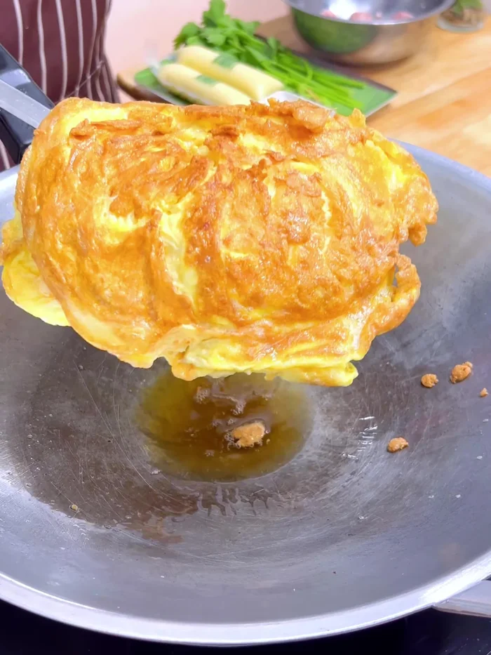 Remove eggs, drain oil, and cut into pieces. Set aside.