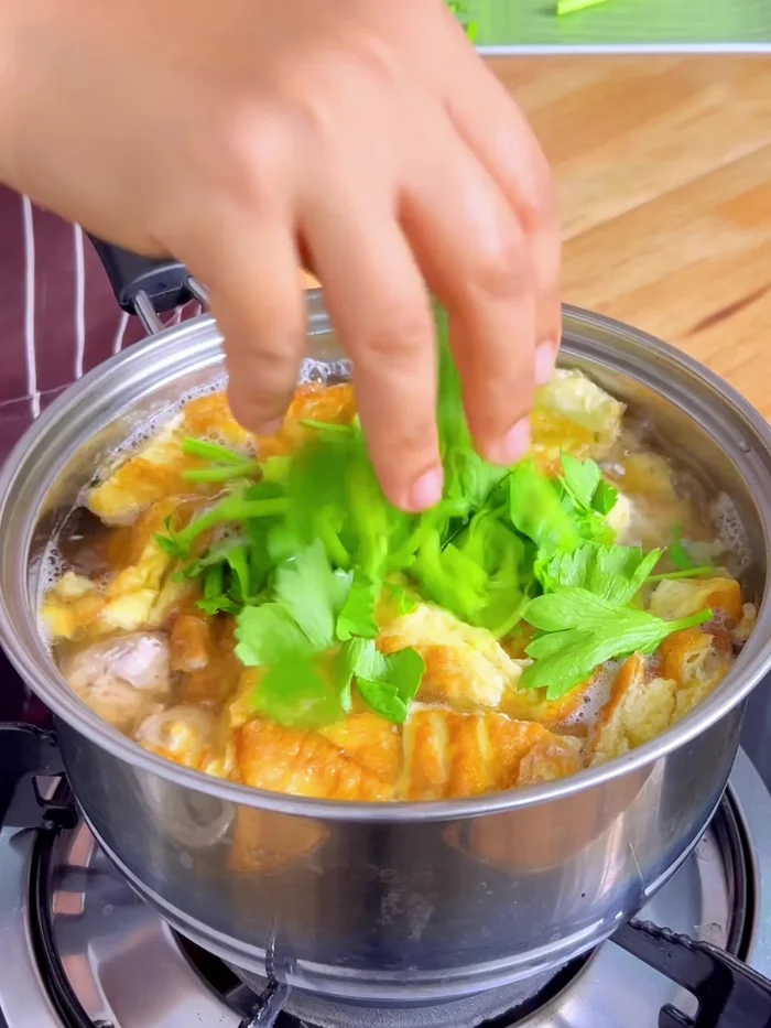 Add kra-chai (fingerroot). Let it simmer briefly.