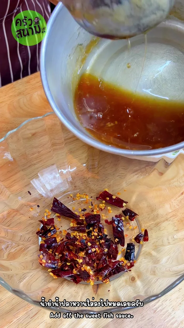 Combine the pounded chilies with the sweet fish sauce, squeeze in half a lemon. Mix well.