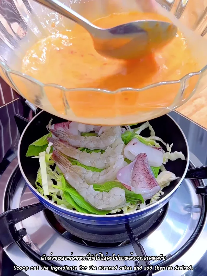 Pour the prepared seafood curry mixture over the seafood and vegetables.