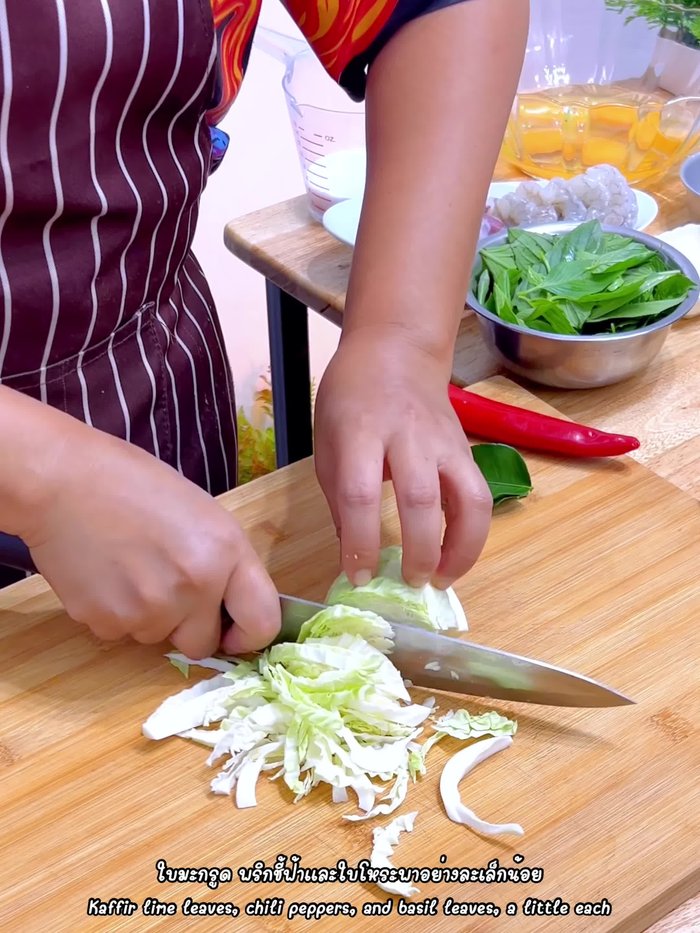 Prepare vegetables for Hor Mok. Include shredded cabbage, kaffir lime leaves, chili leaves, and basil.