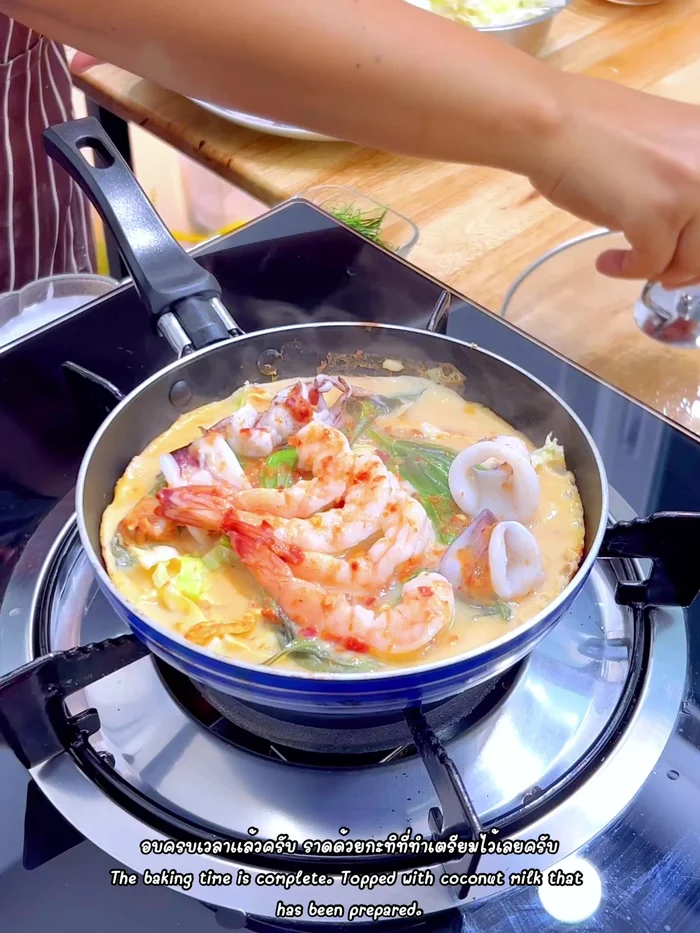 Pour remaining coconut milk over the cooked wrap. Sprinkle with chopped red chili and soy sauce.