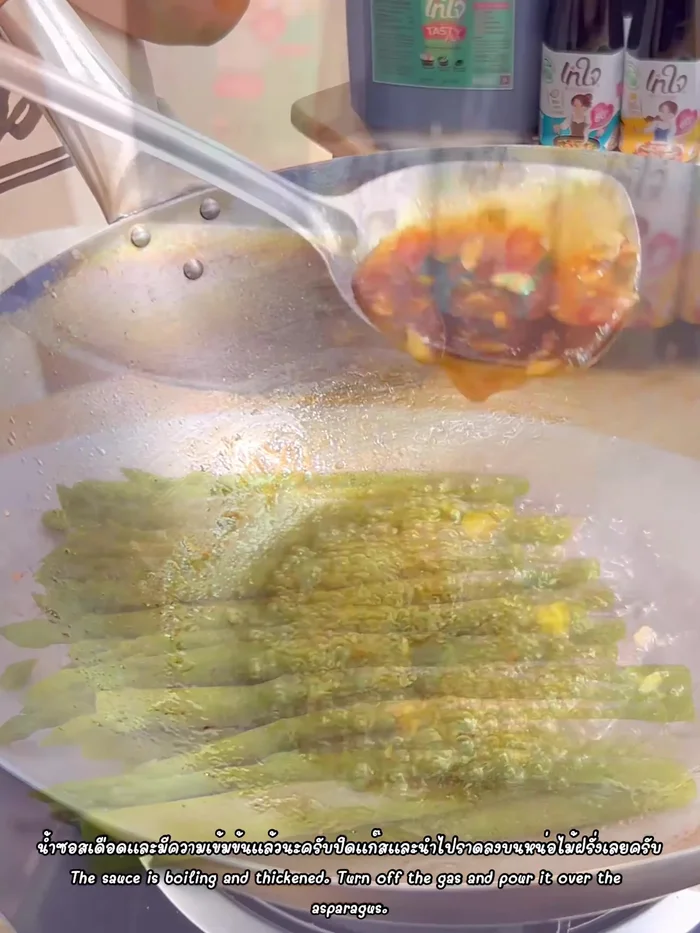 Add the blanched asparagus to the sauce and stir-fry until well coated.