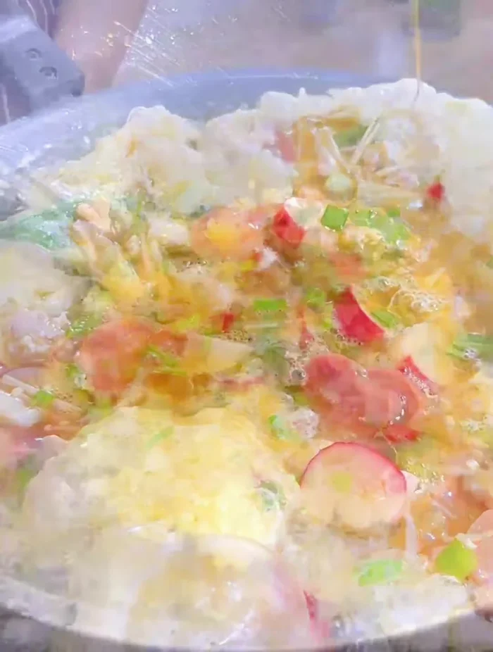 Let the omelet cook until the edges are set. Use a spatula to gently lift the edges and allow uncooked egg to flow underneath.