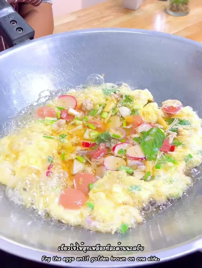 Flip the omelet and cook the other side until golden brown and crispy.