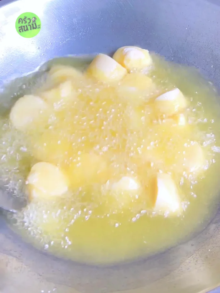 Once the egg tofu is set, use a spatula to separate the pieces to prevent sticking. Continue frying until golden brown and crispy.