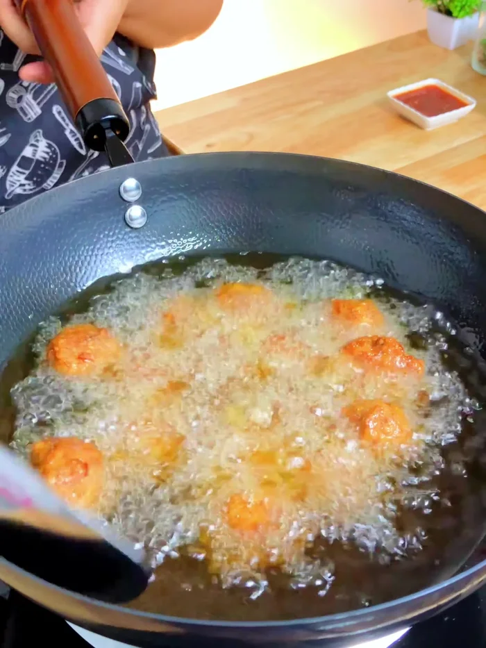 Increase heat to high to crisp the pork balls and prevent them from becoming oily.