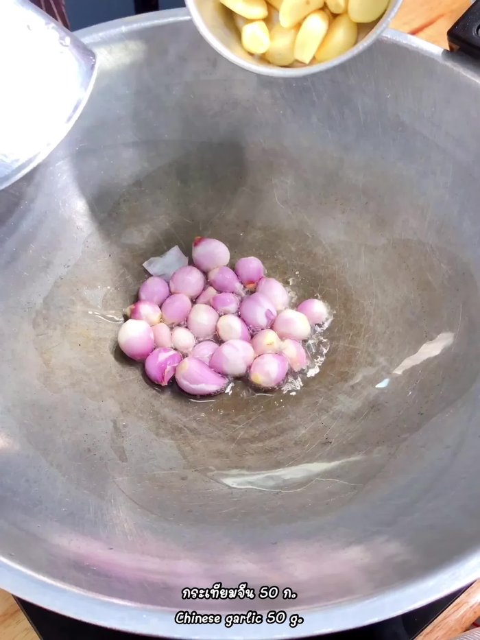 Add 50 grams of shallots, 50 grams of Chinese garlic, and the chilies to the pan with a little vegetable oil. Roast until cooked.