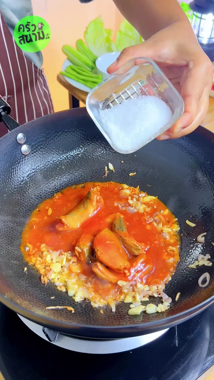 Season with 1 tablespoon of sugar, 1 tablespoon of chili powder, 1 tablespoon of fish sauce, and 1/4 teaspoon of MSG. Stir-fry until well combined.