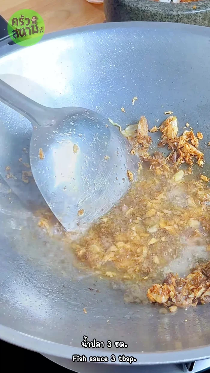 Add 2 tablespoons of water, 3 tablespoons of fish sauce, 1.5 tablespoons of sugar, coconut sugar, and tamarind juice (about 5 tablespoons total). Stir-fry until the sugar melts and the sauce thickens.