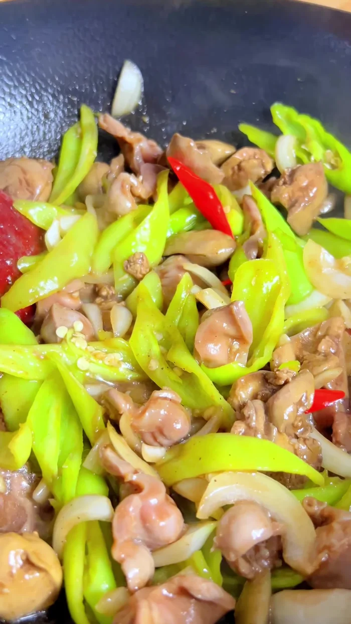 Add spring onions and stir-fry until wilted.