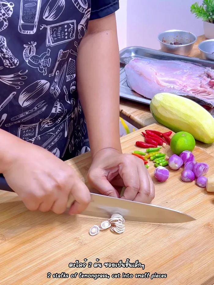 Prepare the herbs: Chop lemongrass, slice galangal, cube lime and shallots, chop chilies, and slice kaffir lime leaves. Add chopped sour mango.