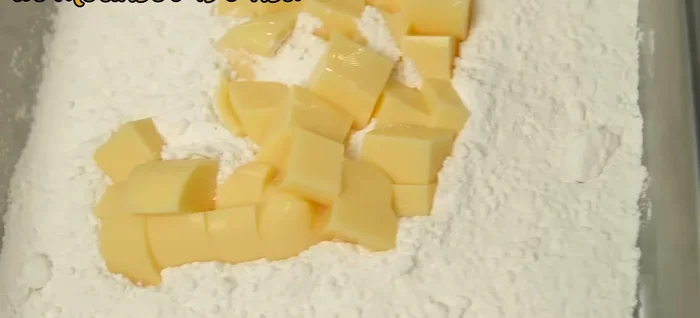 Make the batter: Add the cut egg tofu to a large tray or box. Add all-purpose flour and mix until the flour coats the tofu evenly. A sieve can be used to remove excess flour.