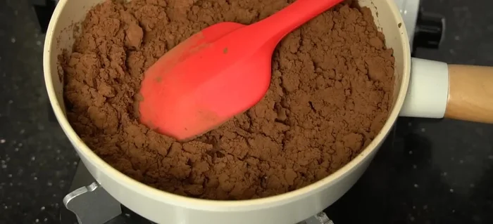 Continue stirring until the mixture thickens and becomes a sticky lump. Adjust the amount of condensed milk as needed to achieve your desired consistency.