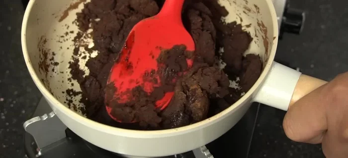 Remove from heat once the mixture is well combined and forms a cohesive lump. It should be thick enough to hold its shape but not too dry.