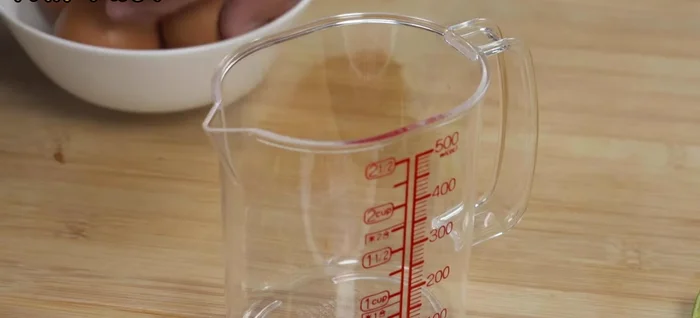 Measure eggs: Crack 4 eggs into a measuring cup. Note the volume (approx. 200ml).