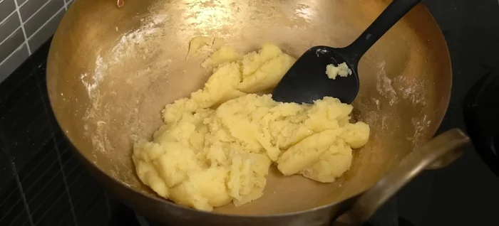 Remove from heat. Gradually add the beaten eggs, mixing until a smooth, slightly sticky dough forms.
