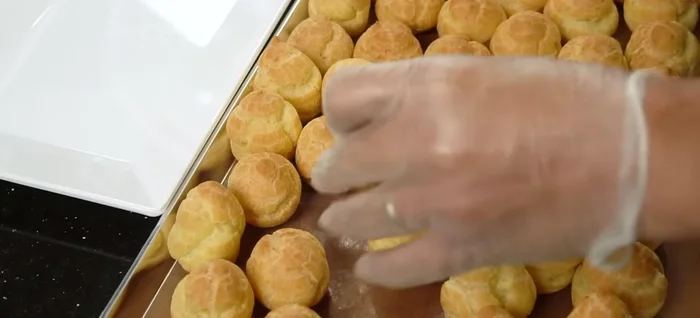 Once cool, pipe the custard filling into the cream puffs through a small hole on the side.