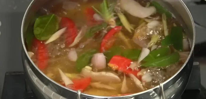 Assemble the dish: Add the cooked omelet, cilantro, and additional chili peppers (to taste) to the Tom Yum soup.