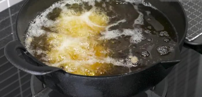 Carefully add the chicken wings to the hot oil, ensuring not to overcrowd the pan. Fry until golden brown and crispy, about 7-8 minutes, stirring occasionally.