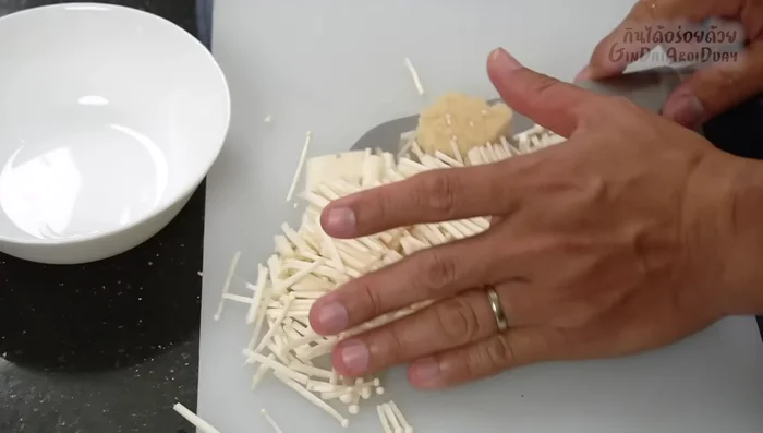 Add glass noodles, mushrooms (e.g., golden enoki), carrots, and other vegetables to the filling. Mix well.